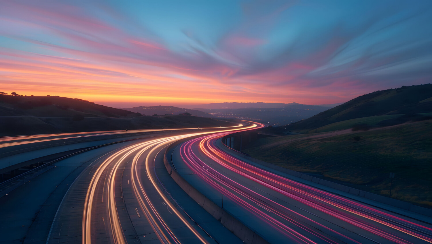 Long-exposure photo of a motorway at sunset shows bright streaks of car lights curving between hills under a colourful sky—a visual echo of momentum highlighted in our 2025-26 Sustainable Investing Report.