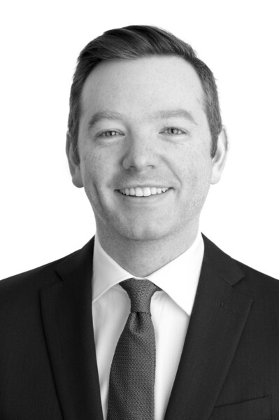 Black and white portrait of Robert Albee, a smiling man wearing a suit and tie.