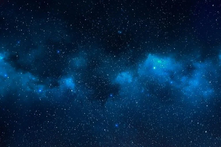 A starry night sky with dense clusters of stars and clouds of blue cosmic dust evokes a sense of future possibilities, much like the transformative potential seen in post-acquisition operational value add.