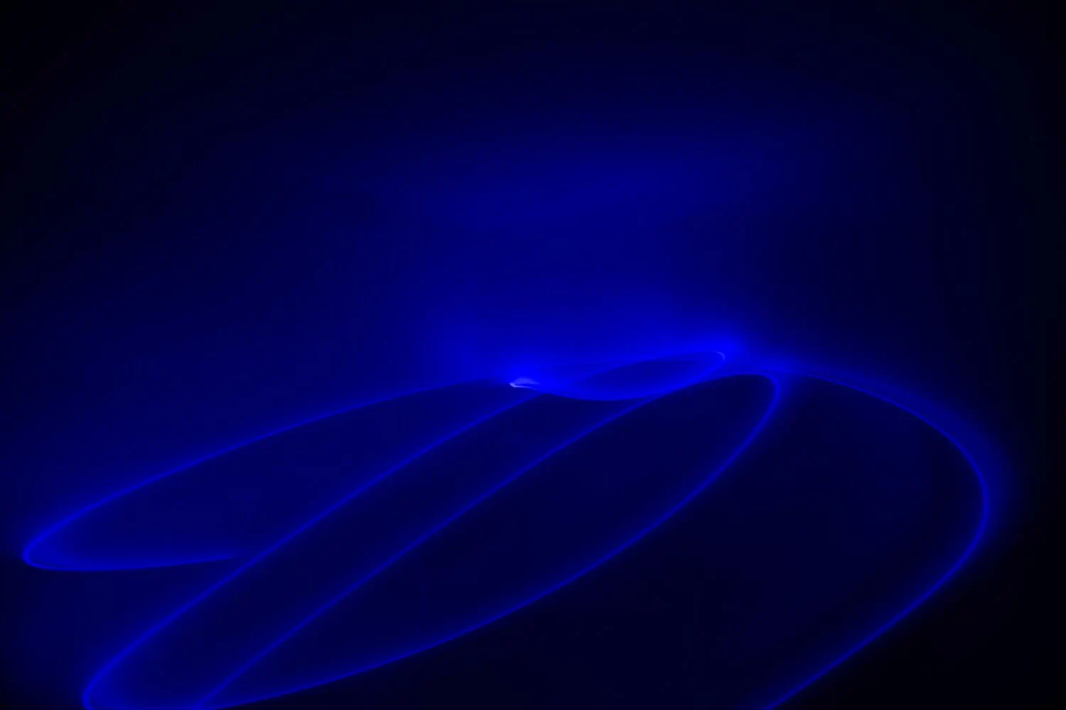 Abstract image showing swirling blue light trails against a dark background, capturing the current outlook on Europe's pandemic response.