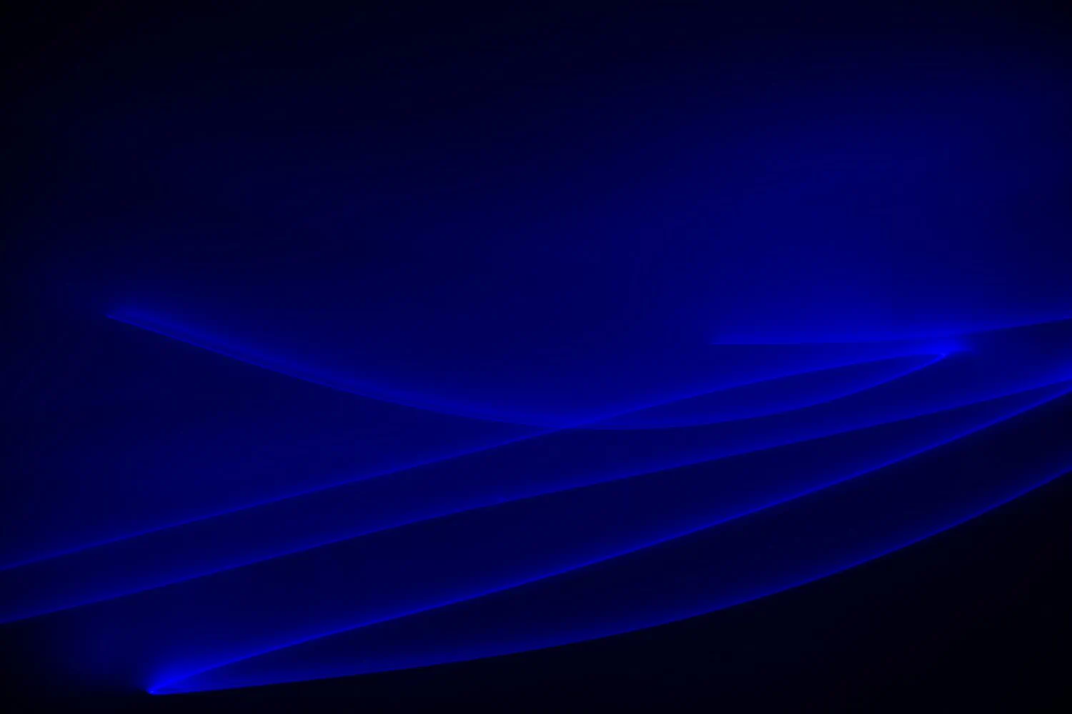 A dark background with blue, glowing, wave-like lines creating an abstract pattern reminiscent of dynamic Covid client communications during crisis management.