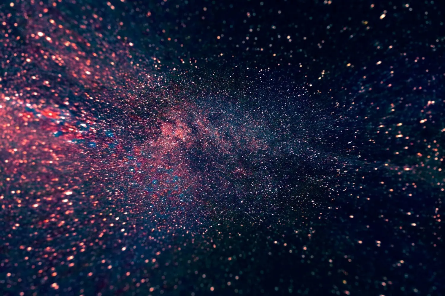 A dense field of stars and cosmic dust in space, with varying shades of pink, blue, and white creating a nebula-like formation against a dark background—it's like the cosmic real estate market revealing its intricate insights for 2021.