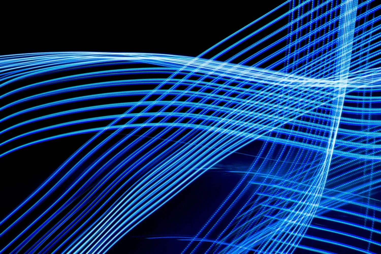 A series of intersecting blue light trails on a black background, creating a dynamic pattern of curved and straight lines, embodying the best practices for visual excellence.