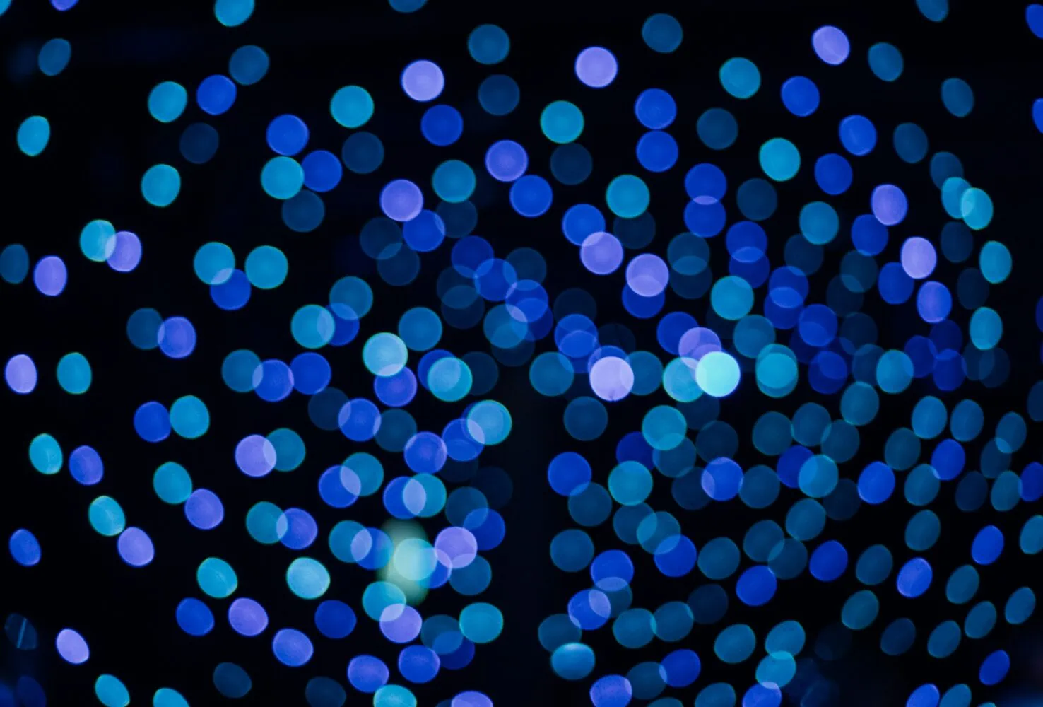 Blurry blue and turquoise light spots are scattered across a dark background, creating a bokeh effect reminiscent of Insights 2022.