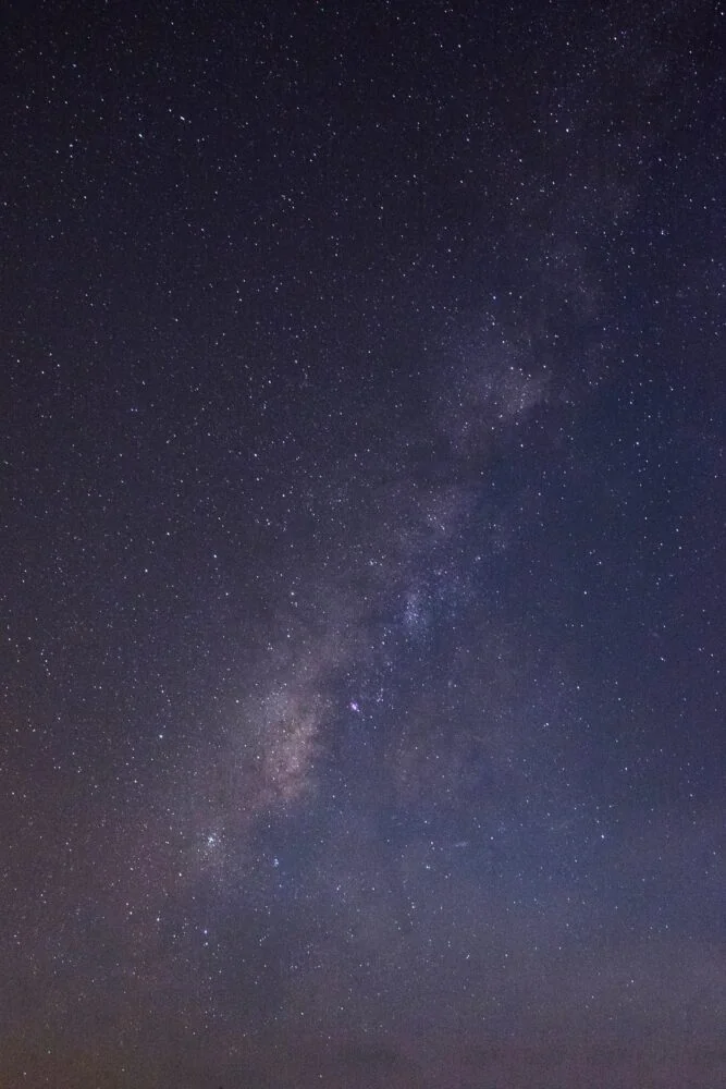 A view of the night sky showing numerous stars and a section of the Milky Way galaxy, reminiscent of the vast potential highlighted in Absolute Return Insights 2021. The sky is dark with a faint gradient of light near the horizon.