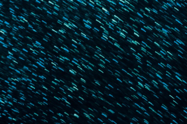 A blur effect image showing streaks of light blue and teal lines moving across a dark background, creating an impression of motion—ideal for a webinar on ESG themes or impact investing.