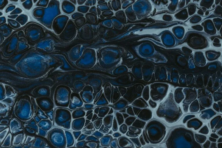 A close-up image of an abstract pattern featuring dark blue and black colors with white speckles, resembling organic or cellular structures, reminiscent of the meticulous attention to detail that best-in-class asset managers embody.